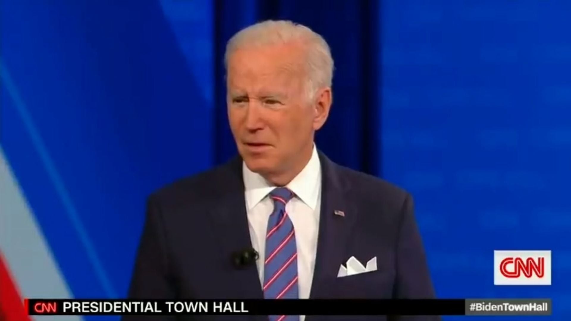 2. Biden Mocks Freedom. A middle-aged man with white hair and fair skin stands speaking at a lectern, wearing a dark suit, white shirt, and a striped tie. He is participating in a presidential town hall, with a CNN logo on the screen and a blue backdrop. Opens a video in a new window.