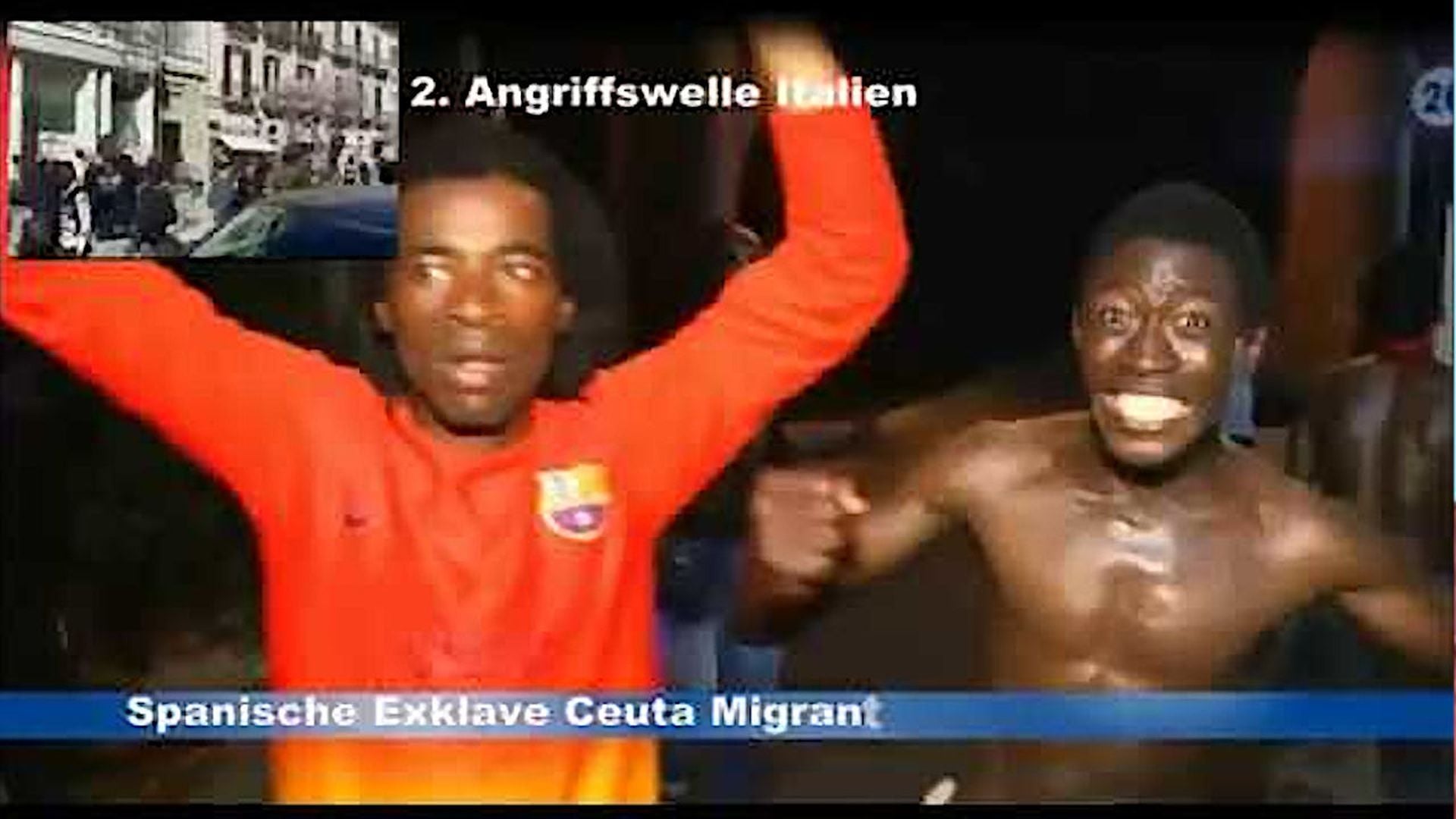 9. Flüchtlingskrise ist ein Kulturkrieg in 3 Angriffswellen. Two men are expressing joy, with the man in a red jacket raising his arms in the air while the other shirtless man clenches his fists near his chest, both men appearing to be in celebration or protest. Opens a video in a new window.