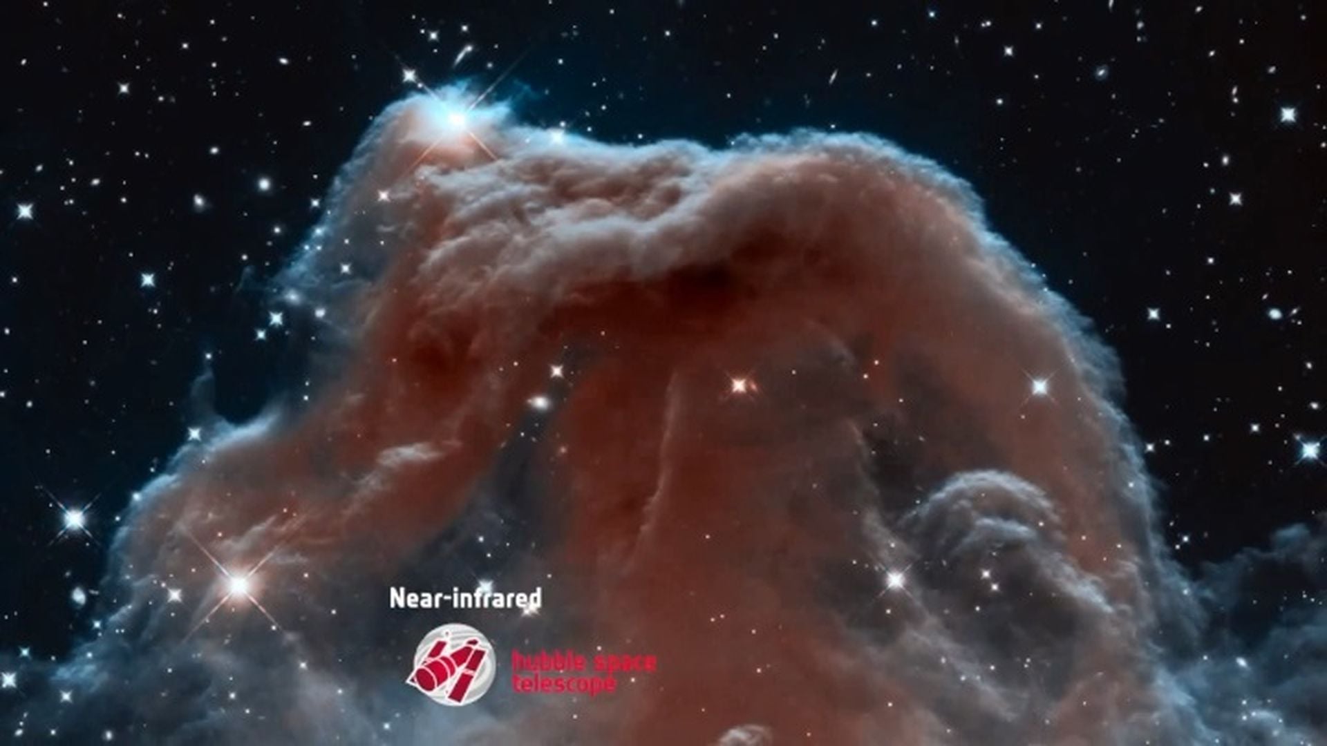 1. ESA - La Nebulosa Cabeza de Caballo en una nueva luz. Image of a celestial cloud formation captured in near-infrared by the Hubble Space Telescope, showcasing swirling nebulas and bright stars. Opens a video in a new window.