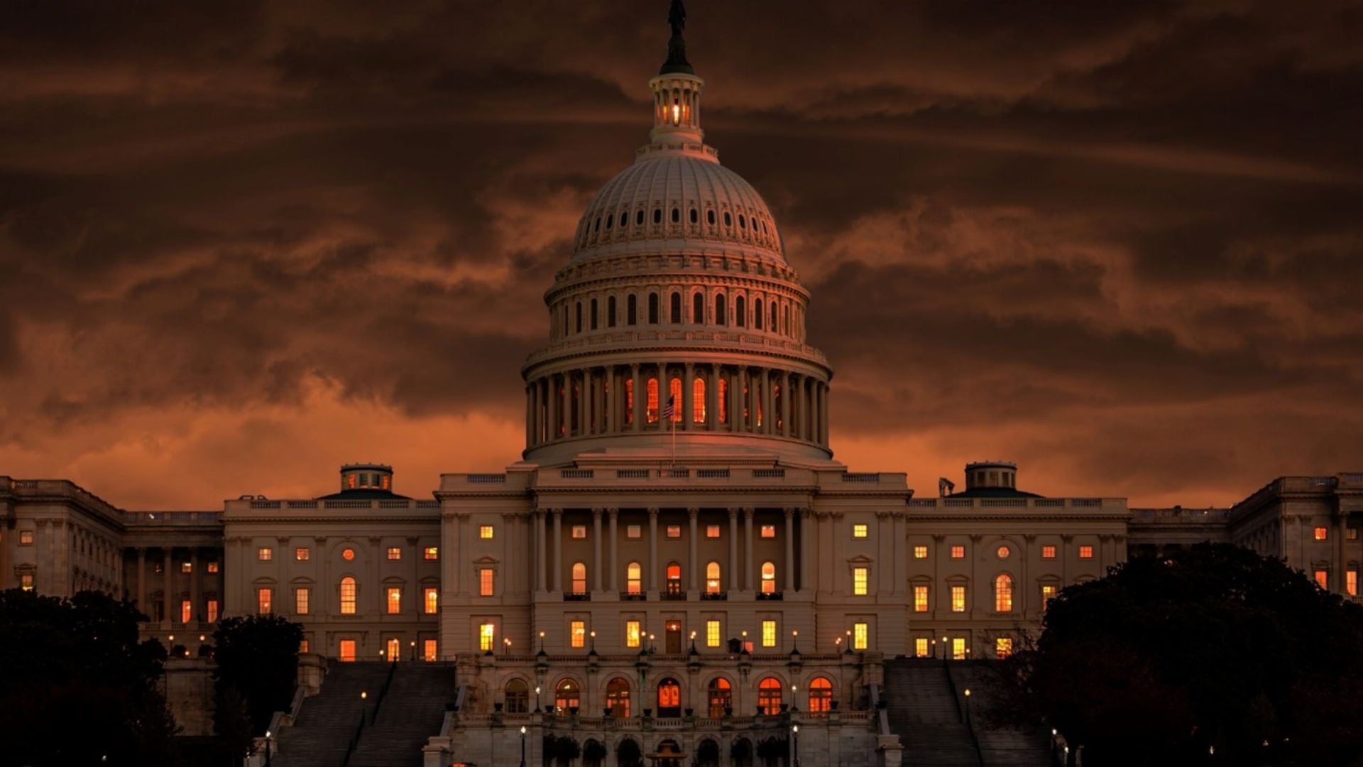 15. Gottes Anweisungen für Demonstranten unserer Zeit. A dramatic view of the United States Capitol Building at twilight with fiery twilight hues and a scattering of clouds, the building's classical architecture illuminated by warm interior lights. Opens a video in a new window.