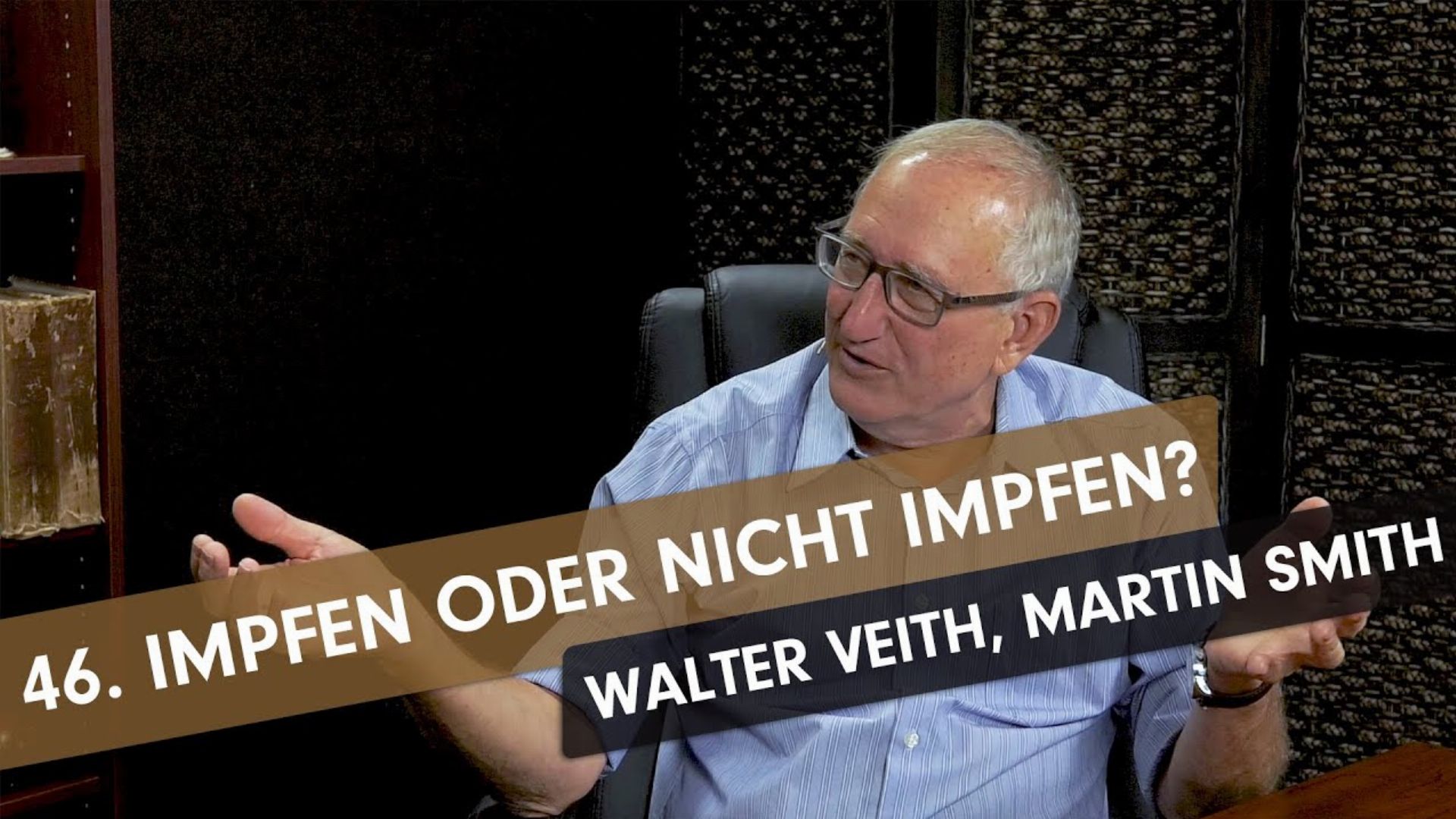 14. Impfen oder nicht impfen – Whats Up, Prof? #46 mit Walter Veith und Martin Smith. An elderly gentleman with glasses, dressed in a light blue shirt, is depicted conversing in a studio setup. He gestures with his hands as he speaks, and a banner with text overlays part of the image reading "46. IMPFEN ODER NICHT IMPFEN? WALTER VEITH, MARTIN SMITH." Opens a video in a new window.