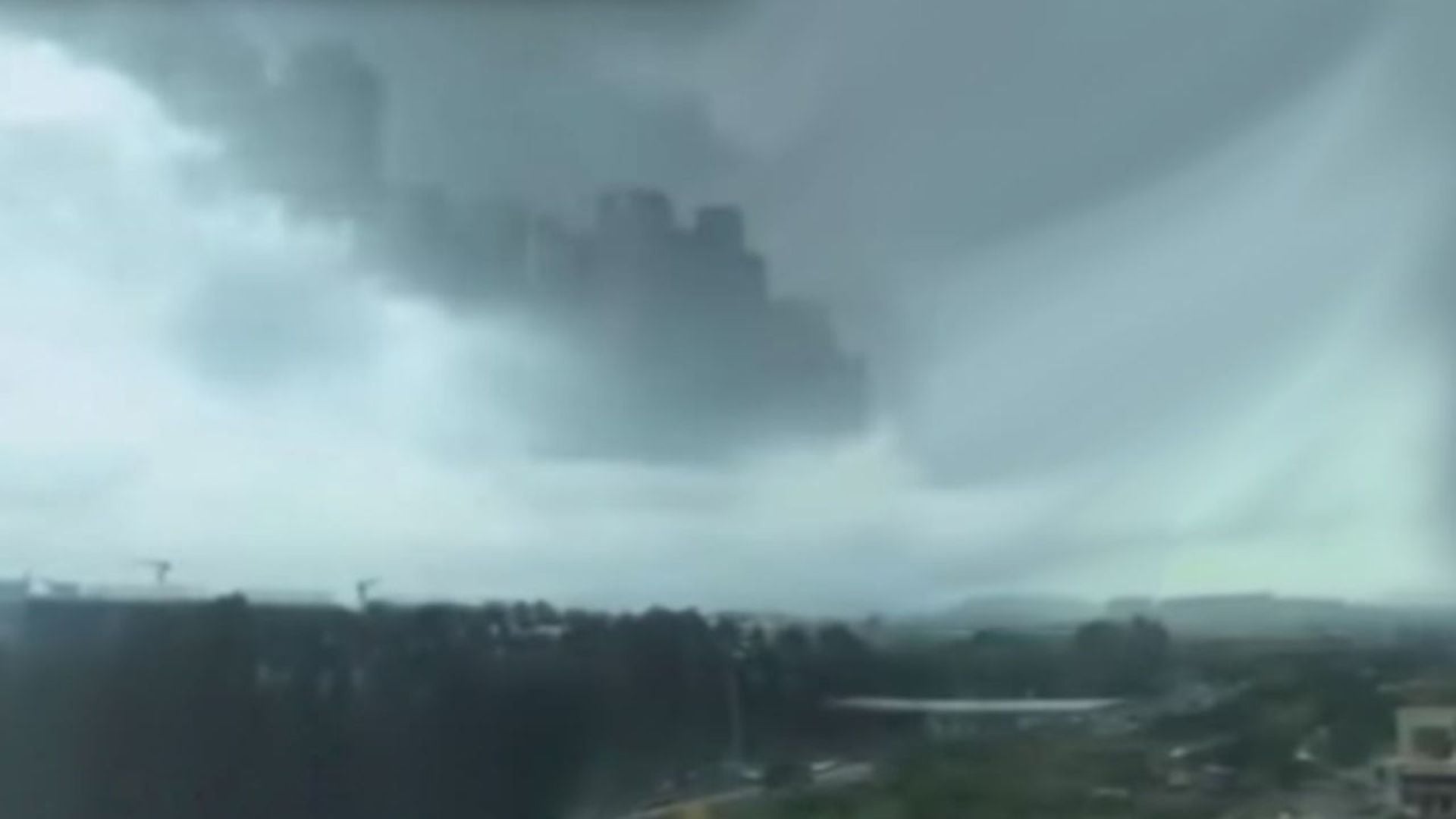 4. Schwebende Stadt über China entdeckt!? | MythenAkte. A vast cloudscape depicts towering cumulus clouds and a sweeping view of an urban area, possibly early in a storm cycle, with varying shades of gray dominating the sky. Opens a video in a new window.